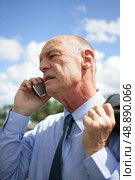 Businessman talking on his mobile phone. Стоковое фото, агентство Ingram Publishing / Фотобанк Лори