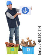 Builder stood with recyclable waste. Стоковое фото, агентство Ingram Publishing / Фотобанк Лори