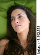 Pensive brunette laying in bed. Стоковое фото, агентство Ingram Publishing / Фотобанк Лори