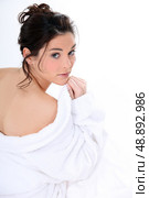 Rear shot of woman removing bathing robe. Стоковое фото, агентство Ingram Publishing / Фотобанк Лори