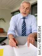 Senior businessman filling in diary. Стоковое фото, агентство Ingram Publishing / Фотобанк Лори