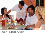 foursome having dinner outdoors. Стоковое фото, агентство Ingram Publishing / Фотобанк Лори