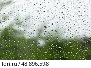 Raindrops scatter across a clear windowpane, macro photo. Стоковое фото, фотограф EugeneSergeev / Фотобанк Лори