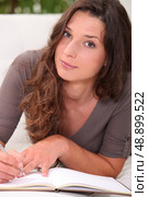 Woman writing in her diary. Стоковое фото, агентство Ingram Publishing / Фотобанк Лори