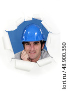 Builder stood behind tear in background. Стоковое фото, агентство Ingram Publishing / Фотобанк Лори