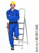 Portrait of a standoffish tradesman with his arms crossed. Стоковое фото, агентство Ingram Publishing / Фотобанк Лори