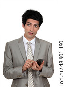 Businessman sending a text message. Стоковое фото, агентство Ingram Publishing / Фотобанк Лори