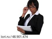 portrait of black businesswoman with glasses lowered holding notebook. Стоковое фото, агентство Ingram Publishing / Фотобанк Лори
