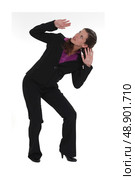 A businesswoman afraid of something falling from the ceiling. Стоковое фото, агентство Ingram Publishing / Фотобанк Лори