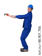 Tradesman using a pipe wrench to drag an invisible object. Стоковое фото, агентство Ingram Publishing / Фотобанк Лори