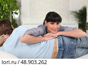 Woman lying on her boyfriend. Стоковое фото, агентство Ingram Publishing / Фотобанк Лори