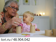 Young child coloring with grandma. Стоковое фото, агентство Ingram Publishing / Фотобанк Лори