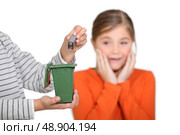 Girl horrified at someone putting a battery in the bin. Стоковое фото, агентство Ingram Publishing / Фотобанк Лори