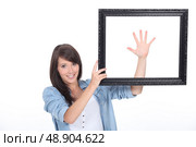 Young brunette with picture frame. Стоковое фото, агентство Ingram Publishing / Фотобанк Лори