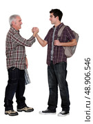 Senior man and young man handshaking. Стоковое фото, агентство Ingram Publishing / Фотобанк Лори