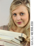 Woman with a stack of books. Стоковое фото, агентство Ingram Publishing / Фотобанк Лори