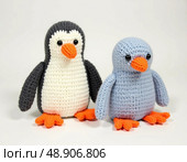 Two whimsical penguin toys crafted with love using colorful yarns, each exhibiting unique designs. Perfect for adding charm to any room or as a thoughtful gift for plush toy lovers Generative AI. Стоковое AI-изображение, AI-художник Юлия Петровская / Фотобанк Лори