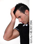 Man suffering from a throbbing headache. Стоковое фото, агентство Ingram Publishing / Фотобанк Лори
