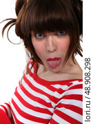 Sticking out her tongue. Стоковое фото, агентство Ingram Publishing / Фотобанк Лори