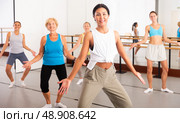 Group of happy women different ages practicing zumba in dance class. Стоковое фото, фотограф Яков Филимонов / Фотобанк Лори