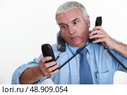 businessman overwhelmed with phone calls. Стоковое фото, агентство Ingram Publishing / Фотобанк Лори