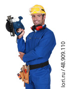 young blue collar with protective equipment and sander machine. Стоковое фото, агентство Ingram Publishing / Фотобанк Лори