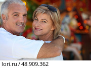 Middle aged man with his arm around his wife. Стоковое фото, агентство Ingram Publishing / Фотобанк Лори