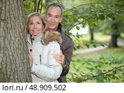 Middle-aged couple strolling in a public park. Стоковое фото, агентство Ingram Publishing / Фотобанк Лори