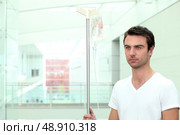Man stood with IV drip. Стоковое фото, агентство Ingram Publishing / Фотобанк Лори