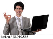young handsome businessman with laptop making okay sign. Стоковое фото, агентство Ingram Publishing / Фотобанк Лори