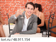 Man toasting with glass. Стоковое фото, агентство Ingram Publishing / Фотобанк Лори
