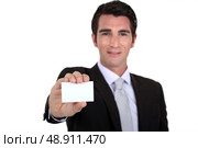Confident businessman flaunting business card. Стоковое фото, агентство Ingram Publishing / Фотобанк Лори