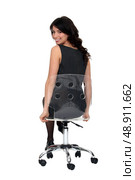 Attractive woman sitting on a see-through swivel chair. Стоковое фото, агентство Ingram Publishing / Фотобанк Лори