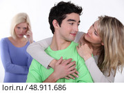 couple in love and jealous woman in background. Стоковое фото, агентство Ingram Publishing / Фотобанк Лори