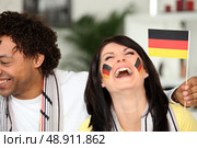 Couple supporting the German football team. Стоковое фото, агентство Ingram Publishing / Фотобанк Лори