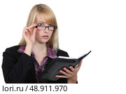 A concerned business professional looking up from her agenda. Стоковое фото, агентство Ingram Publishing / Фотобанк Лори
