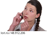 Doubtful woman talking on her mobile phone. Стоковое фото, агентство Ingram Publishing / Фотобанк Лори