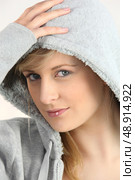 blue-eyed blonde wearing with hand on hood. Стоковое фото, агентство Ingram Publishing / Фотобанк Лори