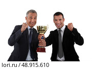 Businessmen holding a golden cup. Стоковое фото, агентство Ingram Publishing / Фотобанк Лори