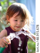 Young child playing with a hose. Стоковое фото, агентство Ingram Publishing / Фотобанк Лори