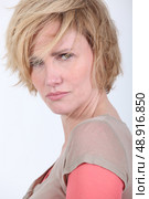 50 years old woman with tousled hair looks anger or in trouble. Стоковое фото, агентство Ingram Publishing / Фотобанк Лори