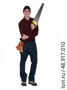 Handyman with a handsaw. Стоковое фото, агентство Ingram Publishing / Фотобанк Лори