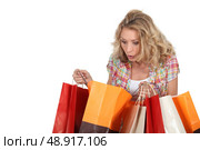 Woman looking in shopping bags. Стоковое фото, агентство Ingram Publishing / Фотобанк Лори