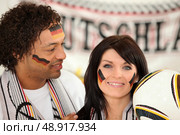 German man and woman ready to support their national team. Стоковое фото, агентство Ingram Publishing / Фотобанк Лори