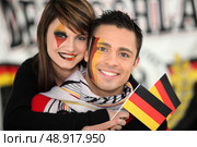 Couple supporting the German football team. Стоковое фото, агентство Ingram Publishing / Фотобанк Лори