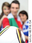 Football fans holding a ball. Стоковое фото, агентство Ingram Publishing / Фотобанк Лори