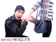 Young thief stealing woman’s bag. Стоковое фото, агентство Ingram Publishing / Фотобанк Лори
