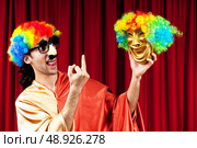 Actor with maks in a funny theater concept. Стоковое фото, агентство Ingram Publishing / Фотобанк Лори