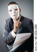 Industrial espionate concept with masked businessman. Стоковое фото, агентство Ingram Publishing / Фотобанк Лори