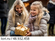 A Tender Gift: A Womans Joyful Kneel Next to a Little Girl Holding a Present. Стоковое AI-изображение, AI-художник Данила Большаков / Фотобанк Лори